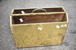 A mid 20th-century hand beaten brass free standing Canterbury, having repetitive circular