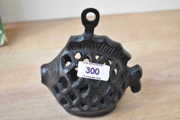 A small 20th-century Japanese cast iron fish lantern candle holder, that can either be free standing