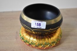 A contemporary Tibetan brass singing bowl, also known as a Himalayan bowl or standing bell,