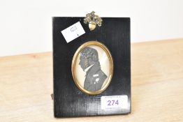 A 19th-century silhouette portrait miniature of a gentleman, featuring a gilt-brass mount set within