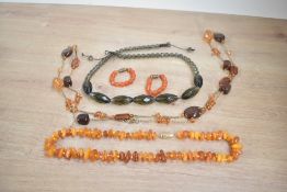 A small collection of beaded jewellery, including an amber chip necklace