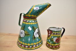 Two 20th-century traditional metal bargeware watering cans, both featuring colourful floral and