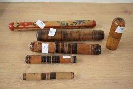 A quantity of late 19th to early 20th-century turned wood needle cases, to include a large floral