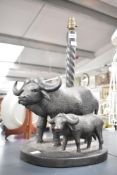 A 20th-century African Art wooden lamp base, carved in the form of a water buffalo and calf, with