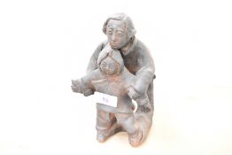 A 20th-century Chinese hand formed terracotta sculpture depicting a mother and child dressed in