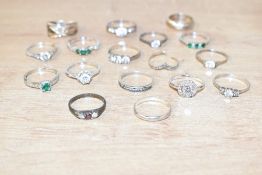 An assortment of silver and white metal rings, including cubic zirconia set, bands and paste set