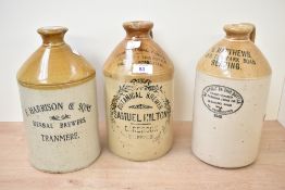 Three 19th/20th-century stoneware flagon jugs, featuring a two-toned design with black