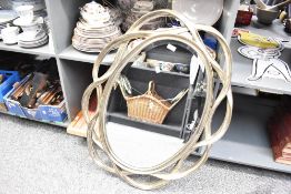 A large contemporary Hookes Reproduction Antiques Company resin mirror, of oval-shape with