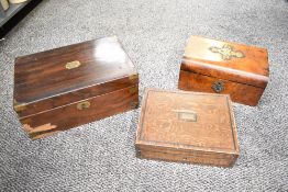 Three 19th-century wooden boxes, comprising two writing desks and a sewing box, each featuring brass