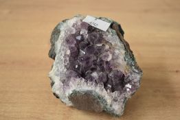 A 20th-century raw Amethyst geode, featuring a deep purple quartz, approximately 12cm diameter.