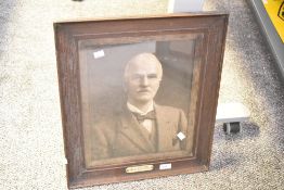 A large early 20th-century framed portrait photograph, with a commemorative plaque that reads 'W.