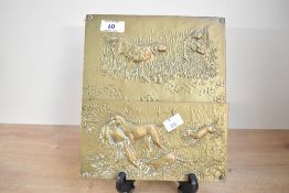 A 20th-century brass letter rack, featuring an embossed fox hunting design, wall hanging hook to