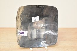 A 20th Century Borrowdale Staybrite stainless steel dish having hand beaten decoration to rim,
