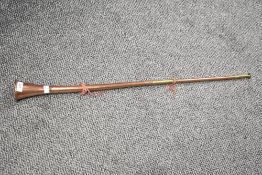 A long 20th-century copper and brass hunting horn, unmarked, 84cm, condition is consistent with