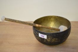 A 20th-century Tibetan brass singing bowl, featuring engraved floral and foliate motif decoration,