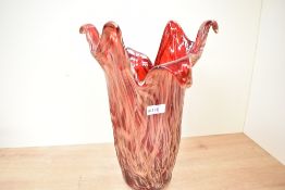 A large 20th-century Murano-style art glass vase, of a red abstracted form with gold detailing,