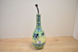 A contemporary ceramic cruet bottle, having colourful tube-lined decoration of abstract floral and