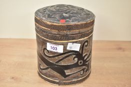 A 20th-century Chinese hand carved wooden box, of cylindrical form, featuring a large dragon-like