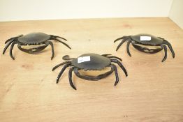 Three mid to late 20th-century metal decorative crabs, featuring individually crafted legs, shells
