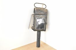 An early 20th-century metal hand held miners lamp, in the candle lantern style, having glass