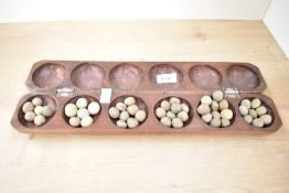 A vintage mancala games board, measuring 42cm long.