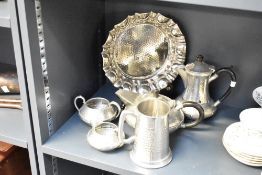 A selection of hammered pewter items comprising stein, four piece tea set and circular tray with