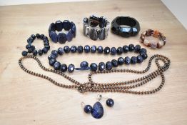 A stackers jewellery tray containing a small selection of modern costume jewellery including blue