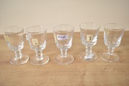 A collection of five 20th-century Cumbria Crystal footed goblets, having smooth bowls and double