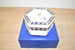 A 20th-century Royal Crown Derby China 'Keddleston' hexagonal trinket box, having a lid made