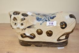 A 19th/20th-century Chinese Qing Dynasty-style Cizhou stoneware headrest, of cat-form having a