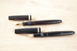 Two Parker Duofold fountain Pens. A aerometric fill in Black with Parker 14K England 25 nib, and a