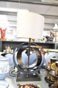 A contemporary British Home Stores metal table lamp, of abstract form, having a grey satin-style