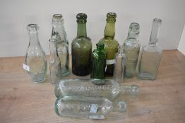 A collection of eleven 20th-century Codd-neck and similar bottles, featuring examples marked '