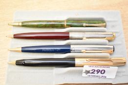 Four Parker propelling pencils. A Parker 51 in maroon with a rolled silver cap, a Parker 17 in