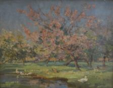 Alexander Carruthers Gould (British 1870 - 1948) Oil on board, a Spring time river scene with pink