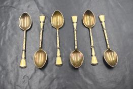 A cased set of George V silver and guilloche enamel coffee spoons, having yellow guilloche enamel to