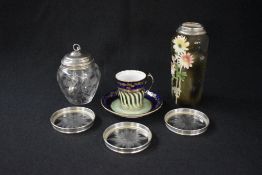 A George V silver mounted glass condiment pit, the silver lid and spoons over the bulbous glass body
