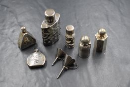 A group of six silver and white metal miniature scent bottles, two being glass with metal mounted,
