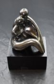 A Devora Jaron contemporary silver figure group, modelled as a couple embracing, marked D.Jaron 925,