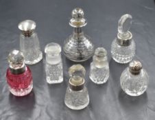 A group of six silver and white mounted scent bottles, one of red glass, three having glass stoppers
