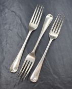 A group of three George III silver Hanoverian pattern forks, having 'GR' monogram to terminals,