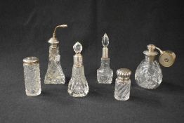 A group of six silver-mounted glass scent bottles, two having glass stoppers, two having vaporisers,