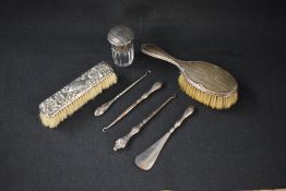 A George V silver capped glass scent bottle, having engine turned decoration to the lid, marks for