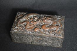 A 20th century Japanese silver plated box, of hinged rectangular form having an ornate dragon and