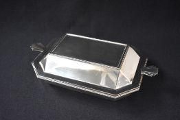 A George V silver Art Deco serving dish, of rectangular form having decorative angular fan handles