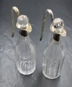 A pair of William IV silver mounted glass oil and vinegar jugs, of cylindrical form, having canted