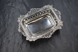 A Victorian silver dish, of rectangular form having a flared scroll and diaper rim with pierced