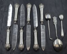 A set of six Edwardian silver handled knives, having decorative scrollwork to terminals, marks for