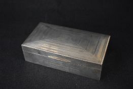 A George V silver presentation cigarette box, of hinged rectangular form having engine turned