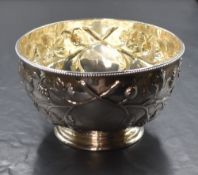 A Victorian silver sugar bowl, having a bead rim with embossed grape vines, raised on circular